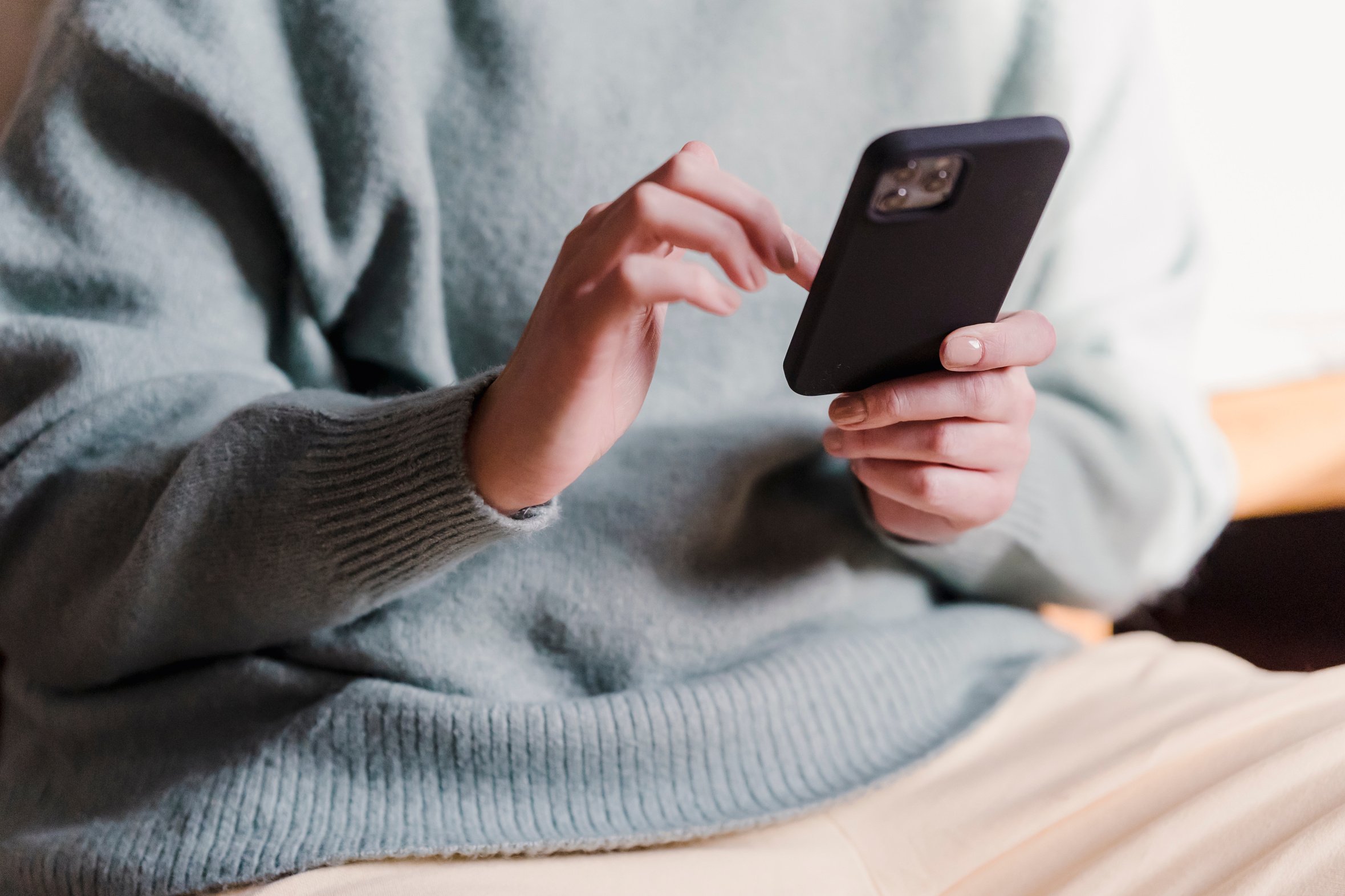 Woman surfing internet with mobile phone